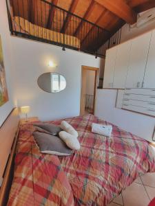 a bedroom with a large bed with pillows on it at Appartamenti Esmera in Desenzano del Garda