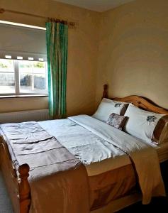 a bedroom with a large bed with a window at Relaxing Break in the Countryside in Foyle Bridge