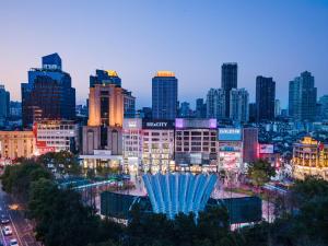 a view of a city at night with a fountain at Holiday Inn Shanghai Nanjing Road by IHG in Shanghai