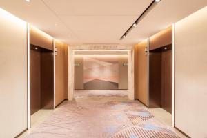 a hallway with a dressing room with a carpet at Holiday Inn Shanghai Nanjing Road by IHG in Shanghai