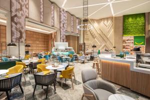 an image of a restaurant with tables and chairs at Holiday Inn Shanghai Nanjing Road by IHG in Shanghai