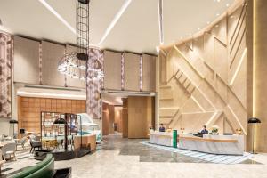 a rendering of a lobby with a staircase at Holiday Inn Shanghai Nanjing Road by IHG in Shanghai