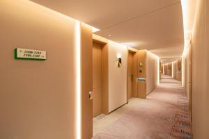 a hallway with a sign on a wall at Holiday Inn Shanghai Nanjing Road by IHG in Shanghai