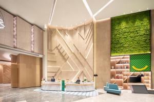 a rendering of a lobby with a large staircase at Holiday Inn Shanghai Nanjing Road by IHG in Shanghai