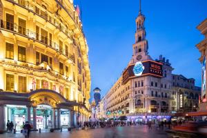 a city street with buildings and a clock tower at Holiday Inn Shanghai Nanjing Road by IHG in Shanghai