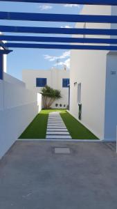 a view of a house with a yard at Casa azul in Playa Blanca