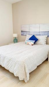 a bedroom with a bed with a white bedspread at Casa azul in Playa Blanca