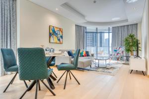a dining room and living room with a table and chairs at RH- Downtown Oasis, Spacious 01 BR in Downtown near Dubai Mall in Dubai