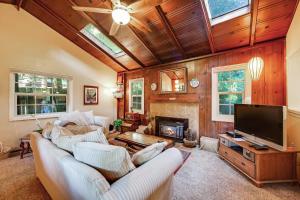 a living room with a couch and a tv at Home on the Range in Guerneville