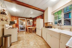 a kitchen with white appliances and a dining room at Home on the Range in Guerneville