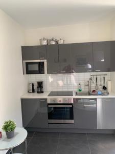 a kitchen with stainless steel appliances and a table at Ferienwohnungen Göhren Rudi-Herzlich Willkommen zu Ihrem Urlaub für Familie, Paare und Tierliebhaber in Göhren