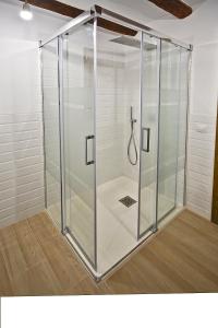 a shower with a glass door in a bathroom at Casa del Tio Vicente in Calaceite +16 photos