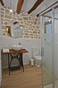 a bathroom with a sink and a toilet at Casa del Tio Vicente in Calaceite