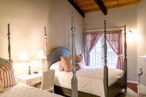 A bed or beds in a room at Merritt House Hotel