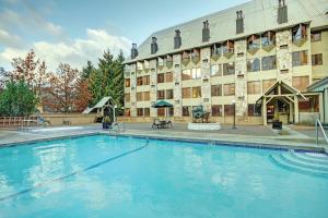 a large swimming pool in front of a hotel at Mountainside Lodge in Whistler