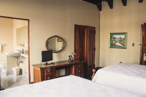 a bedroom with a bed and a mirror at Casa Carmel Bed & Breakfast in Guatemala +24 photos