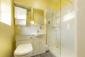 a bathroom with a toilet and a sink and a shower at HK Rooms - Self Catering Rooms in Lowestoft +37 photos