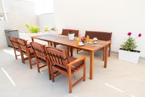 a wooden table and chairs in a room at Entire private top floor with own pool and entrance in Primošten