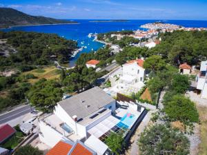an aerial view of a house with a view of the water at Entire private top floor with own pool and entrance in Primošten