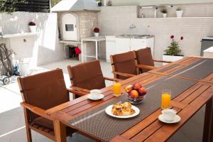 a wooden table with a plate of food on it at Entire private top floor with own pool and entrance in Primošten +37 photos