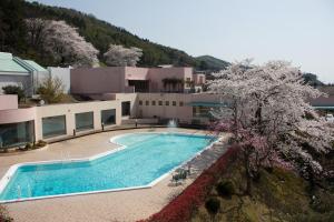 a large swimming pool in front of a building at Kanazawa Kokusai Hotel in Kanazawa