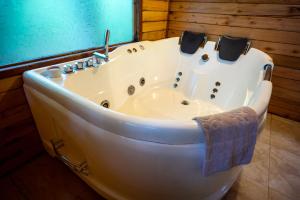 a white bath tub sitting in a room at Mindo Lago Hotel Destino in Mindo