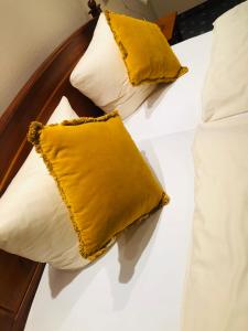 two pillows on a bed with yellow pillows at Da‘ Amici in Horstmar