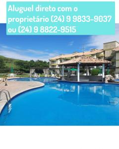 a large swimming pool in a hotel with blue water at Flat Particular Adeias das Aguas Park Resort in Barra do Piraí