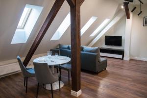 a living room with a couch and a table with chairs at Old Bridge View in Toruń