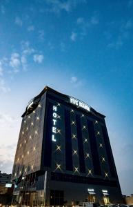 a tall building with a five star sign on it at Five Season Hotel in Al Khobar