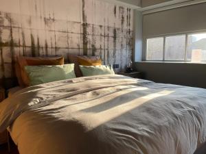 Een bed of bedden in een kamer bij Daen’s Greenhouse