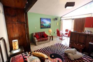 a bedroom with a bed and a living room at Majikal B&B - Jacaranda in Cholula