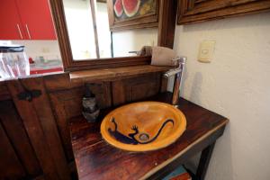 a wooden bowl sitting on top of a wooden table at Majikal B&B - Jacaranda in Cholula
