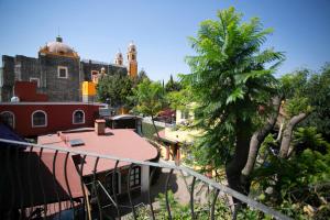 a view of a city with a building and a tree at Majikal B&B - Jacaranda in Cholula