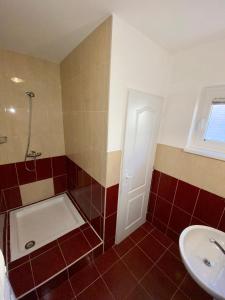 a bathroom with a toilet and a sink and a shower at Apartmánový dom Flóra in Veľký Meder