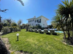 une rangée de bancs devant une maison dans l'établissement Villa Louise-Rose, à Villeneuve-Loubet