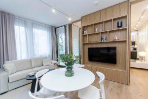 a living room with a white table and a couch at Margo Rentyear Apartments in Gdańsk