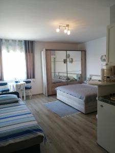 a bedroom with a bed and a large mirror at Apartmani Nevena in Brodarica