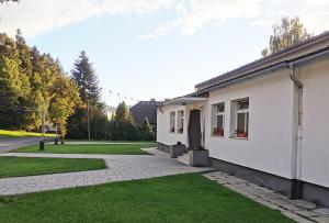 HriňováにあるVegas Hriňová Penziónの緑の芝生が立ち並ぶ白家