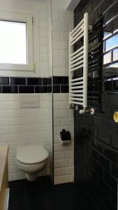 ein Bad mit einem WC und einem Fenster in der Unterkunft Appartement plage in Sopelana