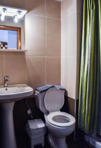 a bathroom with a toilet and a sink at Panorama Hotel in Falasarna