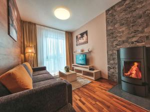 a living room filled with furniture and a fire place at Hotel Crocus in Štrbské Pleso