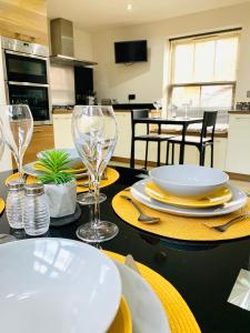 a table with plates and wine glasses on it at Boutique Townhouse Uphill Lincoln in Lincolnshire