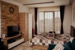 a bedroom with a bed and a large window at Milmari L29 in Kopaonik