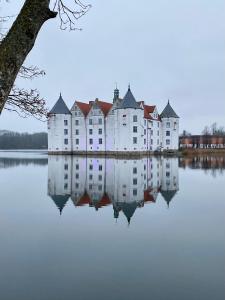 a large castle sitting on top of a lake at Zentrumsnahe schöne Altbauwohnung bis 4 Personen in Flensburg