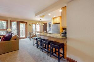 a kitchen and living room with a bar with stools at Lion Square Lodge South 550 in Vail