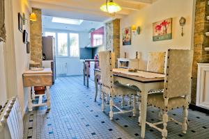 a kitchen with a table and chairs in a room at Band of Brothers House in Sainte-Marie-du-Mont