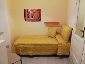Piccola camera con letto con lenzuola gialle di Casa Milena a Rio Marina