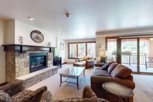 a living room with a couch and a fireplace at Lion Square Lodge North 296 in Vail