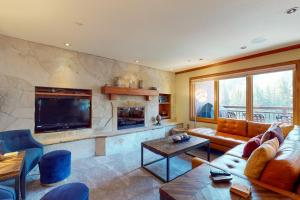 a living room with a couch and a fireplace at Lion Square Lodge South 650 in Vail